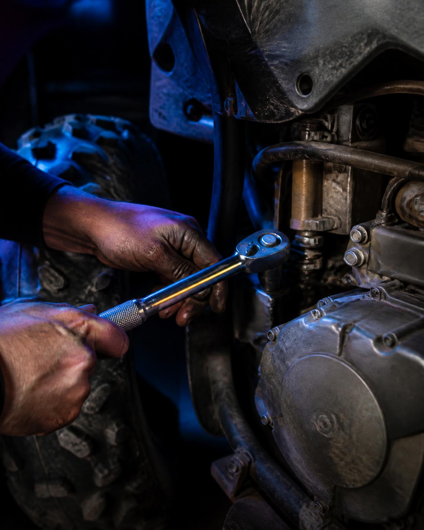 Mechanic wrenching on an ATV